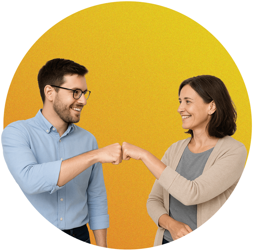 A smiling male co-worker fist bumping a smiling female co-worker.